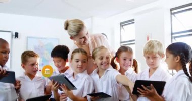 Animation of colorful icons over diverse schoolchildren and teacher using tablets. Global social media, icons and digital interface concept digitally generated video.