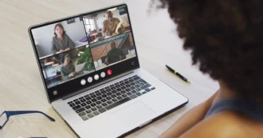 Animation of african american woman having video call on laptop. Business, communication and working in office with technology concept.