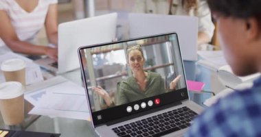 Animation of biracial man having video call on laptop. Business, communication and working in office with technology concept.