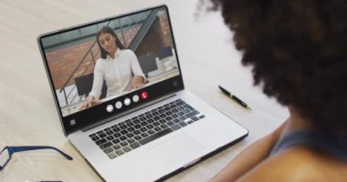 Animation of african american woman having video call on laptop. Business, communication and working in office with technology concept.
