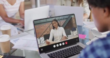 Animation of biracial man having video call on laptop. Business, communication and working in office with technology concept.