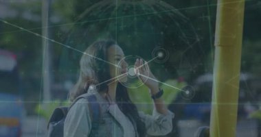 Animation of network of connections with globe over biracial woman stopping bus in city. Global connections, networks and data processing concept digitally generated video.