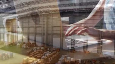 Animation of hands of caucasian woman using laptop over warehouse. Business, delivery services and technology concept digitally generated video.