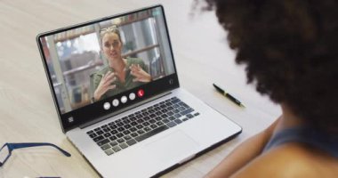 Animation of african american woman having video call on laptop. Business, communication and working in office with technology concept.
