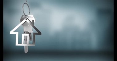 Animation of silver house keys hanging against blurred background with copy space. Relocation and real estate concept