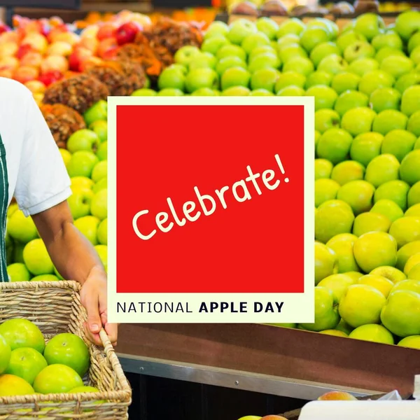 Composition of national apple day text over hands holding basket of apples. National apple day and celebration concept digitally generated image.