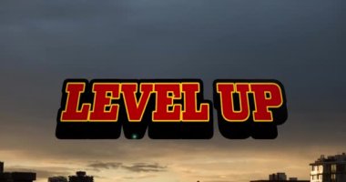 Animation of level up text banner against sunset sky. Video game interface and technology concept