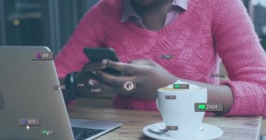 Animation of social media icons with growing numbers over african american woman using smartphone. Global social media, technology and digital interface concept digitally generated video.