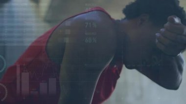 Animation of data with charts moving against tired african man relaxing after excising at gym. Digital composite, multiple exposure, wellbeing, fitness, active lifestyle, sports training, strength.
