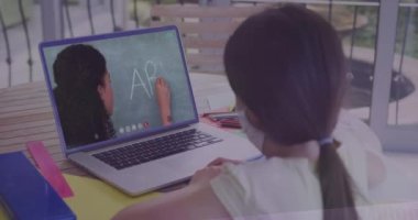 Animation of data processing over rear view of girl wearing face mask having a video call on laptop. School and education technology concept