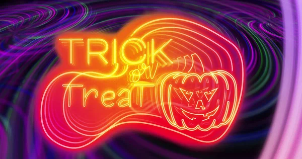 Image of trick or treat over neon lights on black background. halloween tradition and celebration concept digitally generated image.