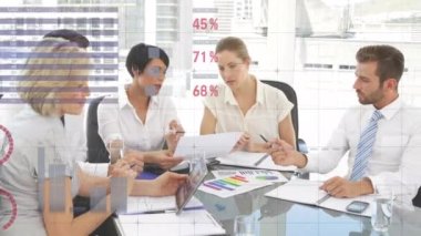 Animation of statistics and financial data processing over business people in meeting. Global business data processing digital interface technology and networking concept digitally generated video.