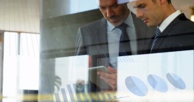 Animation of graph with data processing over diverse business people at office. Global business, computing and digital interface concept digitally generated video.