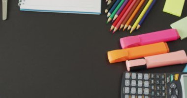 Video of composition with colorful crayons and school tools on grey surface with copy space. School equipment, tools, learning and education concept.
