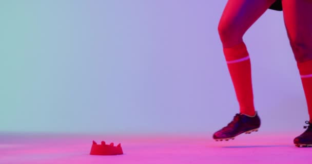African American Female Rugby Player Crouching Rugby Ball Neon Pink — Video