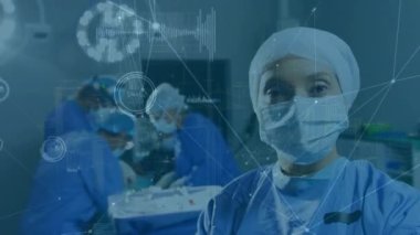 Animation of network and pulse rates over caucasian female doctor with colleagues in background. Multiple exposure, composite, occupation, surgery, operating room, surgeon, portrait.