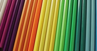 Video of composition with colorful crayons in order of rainbow. School equipment, tools, learning and creativity concept.