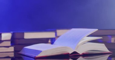 Video of pages in book moving over books and smoke on black background. Halloween, autumn, tradition and celebration concept.