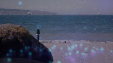 Animation of network of connections over caucasian man at beach. Free time, holidays and digital interface concept digitally generated video.