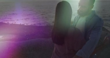 Sahilde birbirini kucaklayan Afrikalı Amerikalı çifte karşı ışık göstergesi. Aşk ve ilişki kavramı