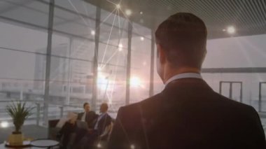 Animation of glowing network of connections over rear view of businessman walking at office. Global networking and business technology concept