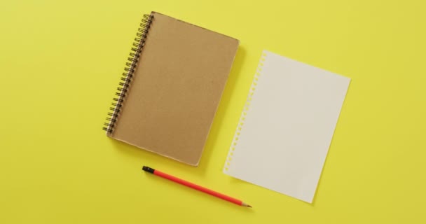 Video Notebook Empty Sheet Copy Space Pencil Yellow Background School — стоковое видео