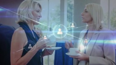 Animation of network of profile icons over two caucasian businesswomen discussing at office. Global networking and business technology concept