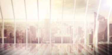 Metal bars on glass window of modern building against cityscape