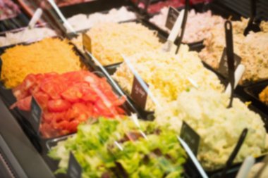 Varieties of salad on display for sale at supermarket