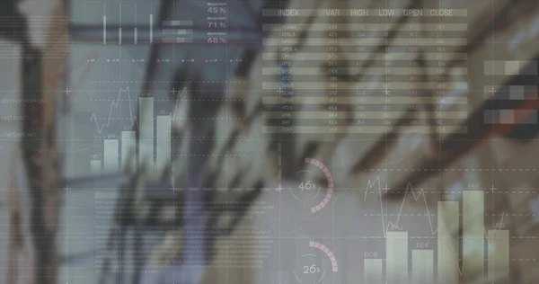 Image of financial data and graphs over packages in warehouse. trade, delivery services, economy and technology digitally generated image.