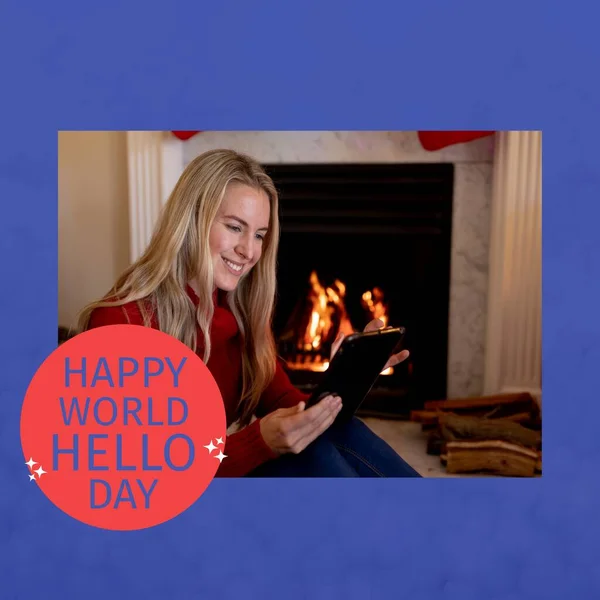 Composition of happy world hello day text with caucasian woman using tablet. Hello day and celebration concept digitally generated image.