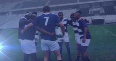 Animation of glowing lights over diverse rugby players in sports stadium. rugby, teamwork, sports and competition concept digitally generated video.