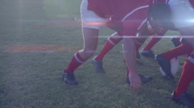 Animation of glowing lights over diverse rugby players in sports stadium. rugby, teamwork, sports and competition concept digitally generated video.