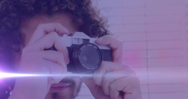 Afrikalı Amerikalı erkek fotoğrafçıya karşı bir ışık lekesi dijital kamerayla fotoğraf çekiyor. dünya fotoğraf günü farkındalık kavramı