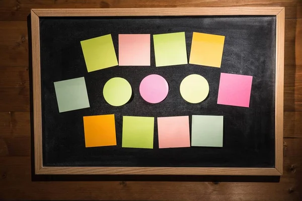 Colourful sticky notes on blackboard with copy space