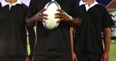 Animation of glowing lights over diverse rugby players in sports stadium. rugby, teamwork, sports and competition concept digitally generated video.