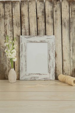 Photo frame and flower vase on table, Close-up