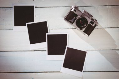 Instant photos on wooden floor with copy space
