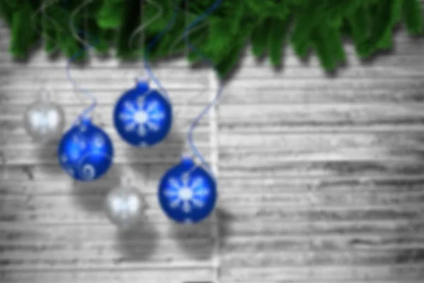 Christmas baubles hanging over wood