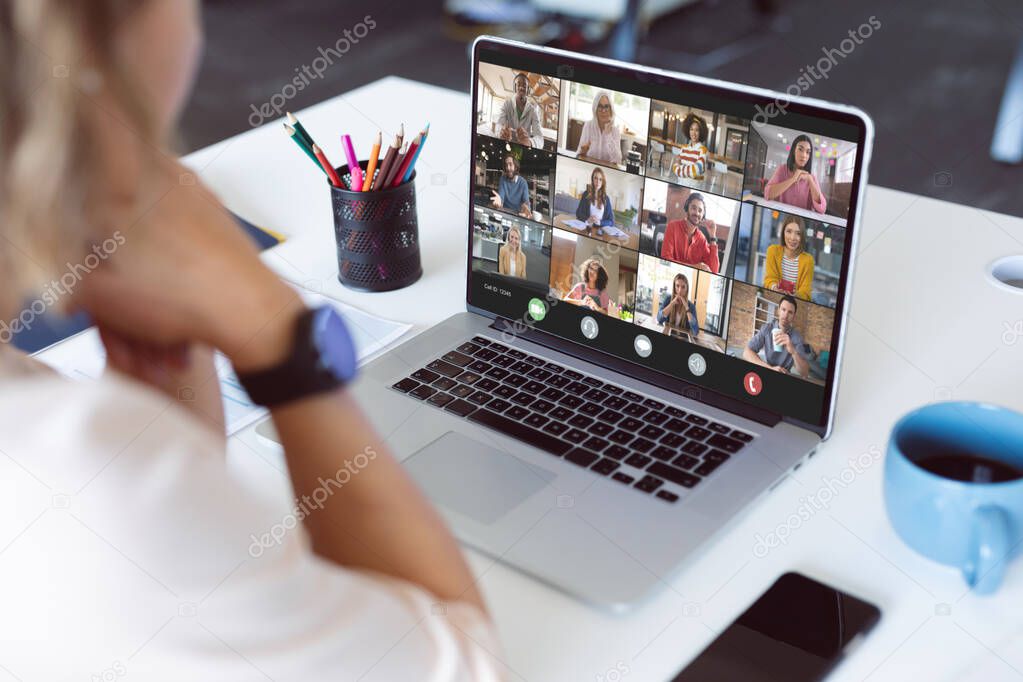 Composition of biracial businesswoman having video call with colleagues. Global business and data processing concept digitally generated image.