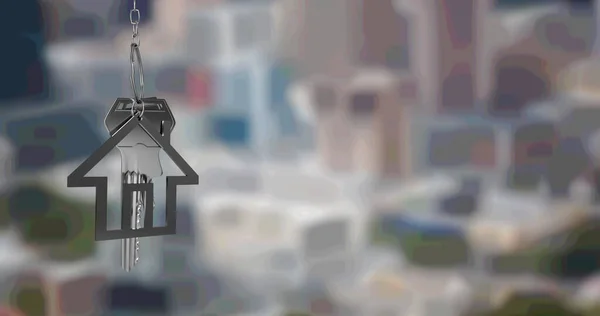 Image of silver house key fob and key, hanging in front of blurred cityscape. property business, home and finance concept digitally generated image.