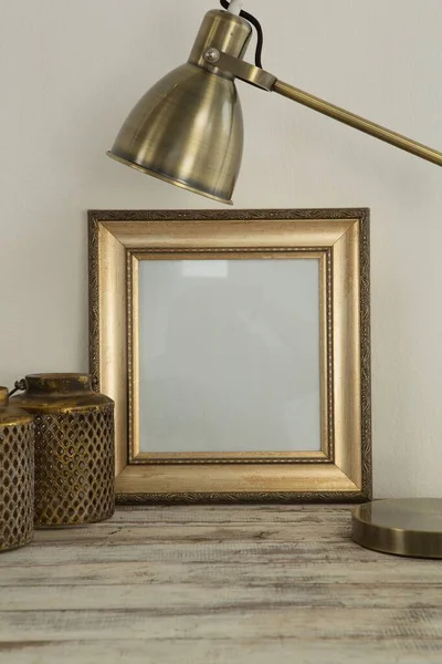 Photo frame and table lamp on table, Close-up