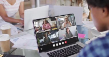African american man using laptop for video call, with diverse business colleagues on screen. Business communication technology and remote home working, digital composite video.