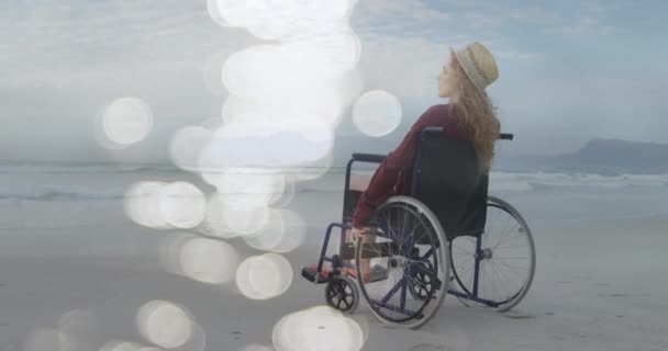 Animation Light Spots Disabled Cuacasian Woman Sitting Wheelchair Beach International — Stock Video