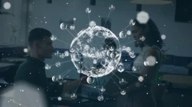 Animation of globe with icons over diverse business people in office. Global business and digital interface concept digitally generated video.