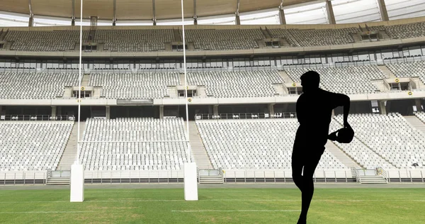 Image of try text with rugby player silhouette at stadium. sport and competition concept digitally generated image.