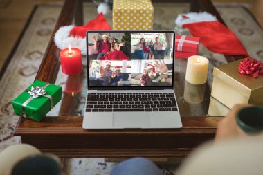 Mutlu Kafkasyalı aile üyeleri Noel zamanı dizüstü bilgisayar grubu görüntülerine el sallıyor. Noel, şenlik ve iletişim teknolojisi.