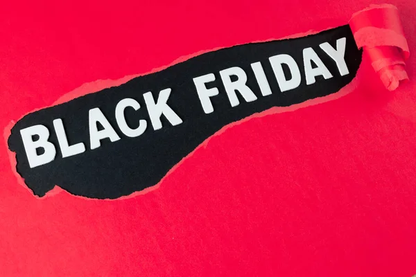 Composition of pink paper and black friday text on black background. Retail, shopping and black friday concept.