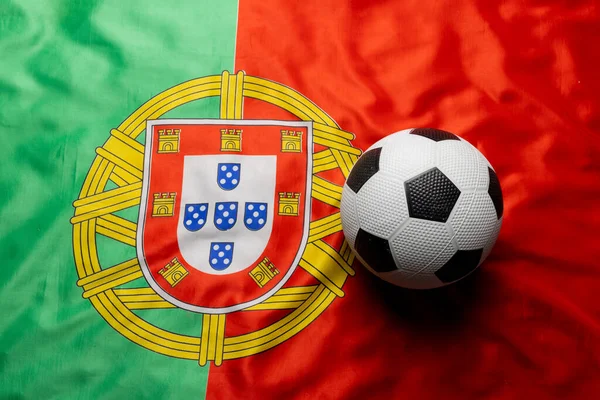 Composition of football over national flag of portugal. Sport, movement, training and active lifestyle concept.