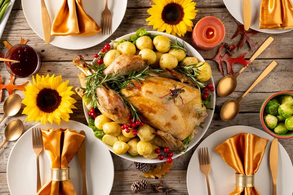 Overhead view of thanksgiving table with roast turkey, potatoes, candles and autumn decoration. Thanksgiving, autumn, fall, american tradition and celebration concept.